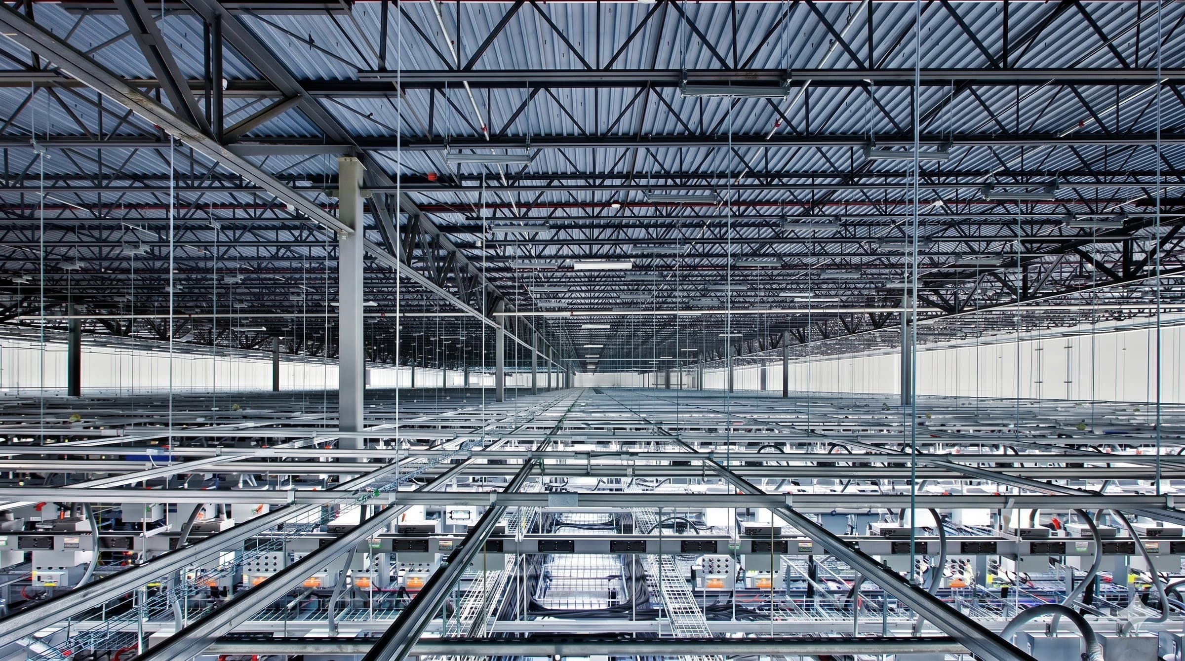 Overhead cable tray infrastructure in a large-scale data center facility under construction
